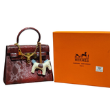 Hermès Kelly 25 Red Matte Python Leather Bag with Horse Charm and Gold Hardware